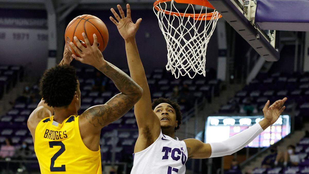 West Virginia’s Jalen Bridges shoots over TCU’s Chuck O’Bannon on Tuesday night at Schollmaier Arena. Bridges finished with nine points as the Mountaineers downed the Frogs.