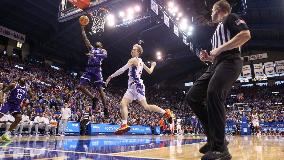 TCU guard Rondel Walker (11) gets inside for a bucket past Kansas guard Gradey Dick (4) on Saturday at Allen Fieldhouse in Lawrence, Kan.