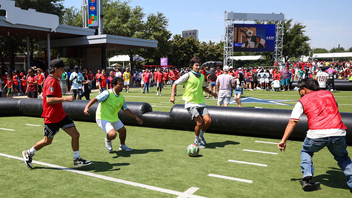 Fans play a mini game of pickup soccer outside of Dallas Stadium before the start of the 2026 FIFA World Cup round of 16 match between Spain and Portugal on Monday, July 6, 2026.