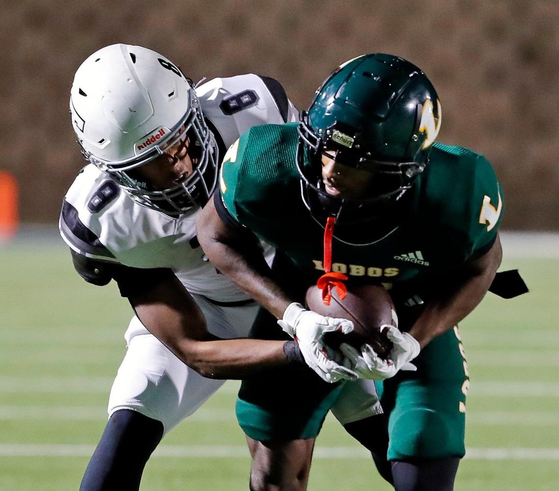 Timberview defensive back Jordan Sanford (8) attempts to strip the ball from Longview wide receiver Jalen Hale (8) in the second half of a UIL Class 5A D1 Region 2 final football game at Mesquite Memorial in Mesquite, Texas, Friday, Dec. 02, 2022. Longview defeated Timberview 37-21. (Special to the Star-Telegram Bob Booth)