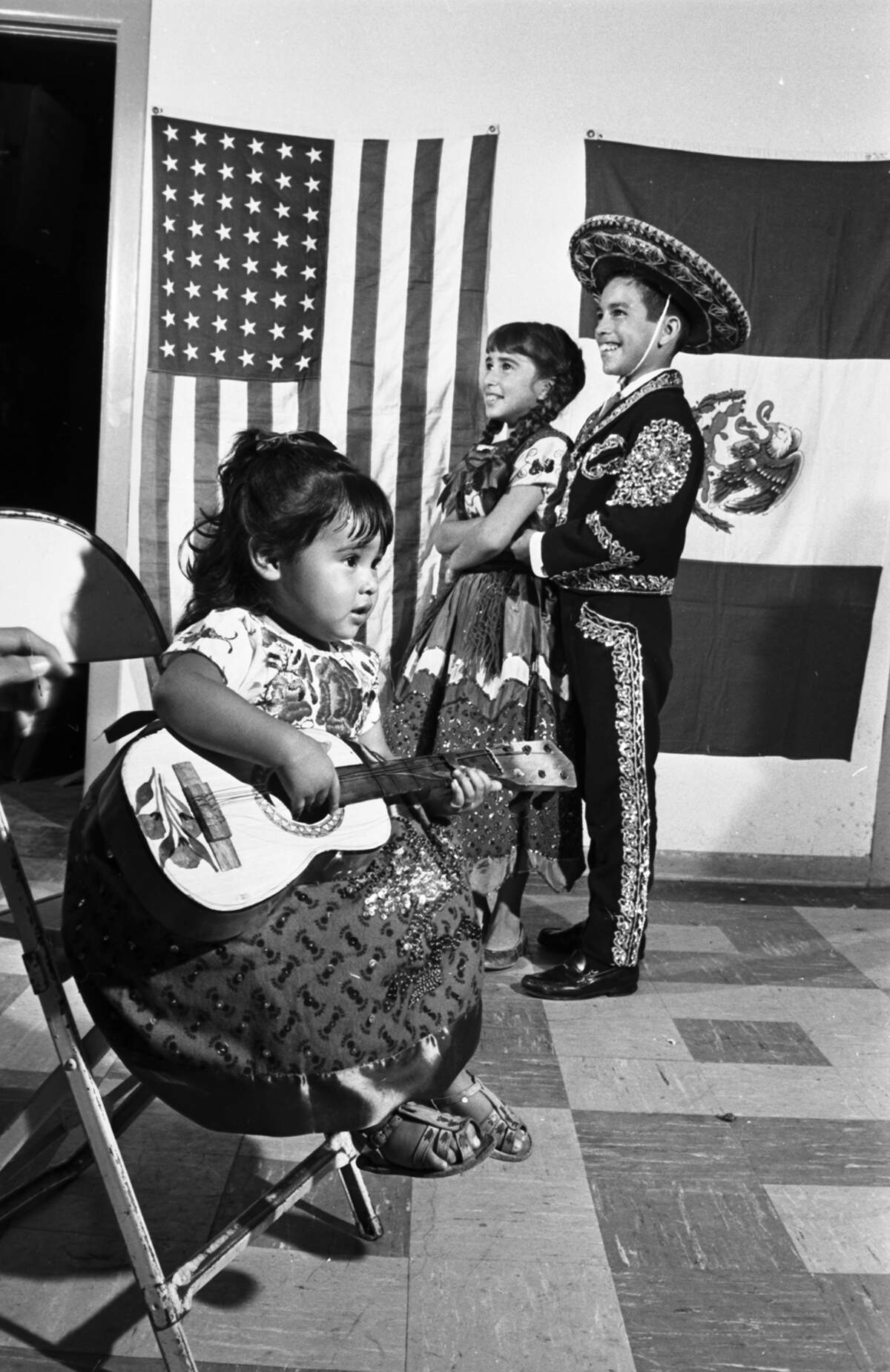 Sept. 1, 1966: Theresa Salinas, 1, strikes a guitar-playing pose as Johnny Gutierrez, 11, and Gloria Flores, 10, wait for the pulsating rhythms of the Mexican Hat Dance. The three will entertain at the Mexican Independence Day Fiesta at Lake Worth Casino. A “Spread the Word” party was staged at Immaculate Heart of Mary Catholic Church.