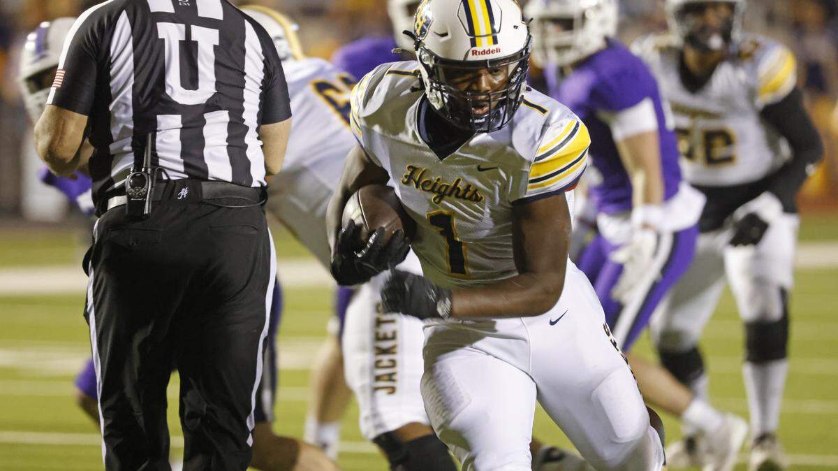 Arlington Heights running back Carson James carries up the middle during the first half against Paschal on Nov. 7 at Farrington Field in Fort Worth.