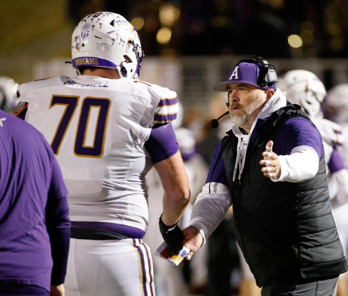Alvarado head coach Casey Walraven congratulates lineman Kaden Mitchell (70) and the rest of the team after a score during the UIL 4A D1 Quarterfinals at Mustang-Panther Stadium in Grapevine, Texas, Friday, Dec. 06, 2024.