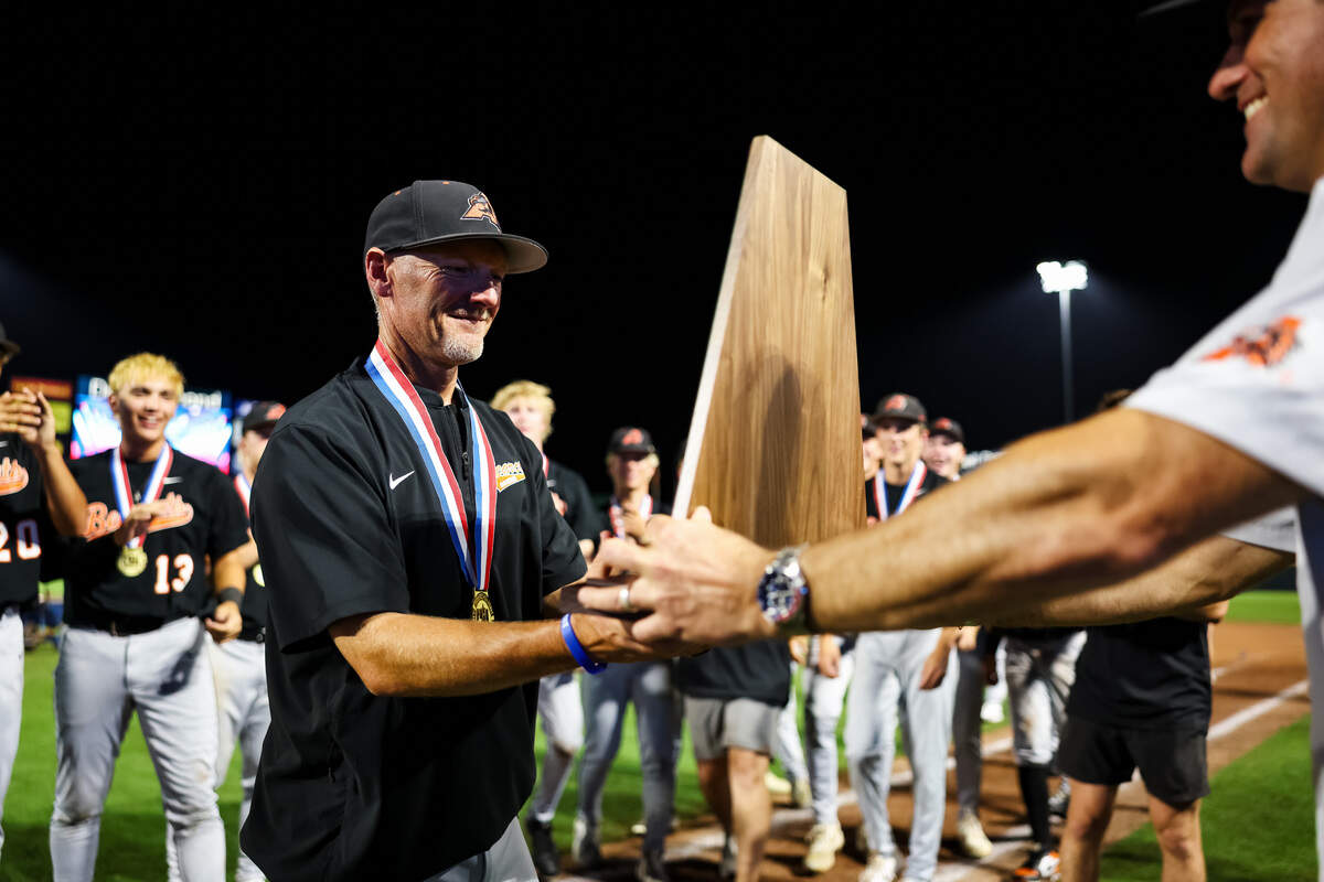 Aledo head coach Chad Barry grabs the championship trophy after a 3-1 win over Montgomery Lake Creek in the UIL Class 5A Division I baseball state championship game at Dell Diamond in Round Rock, Texas, on Friday, June 5, 2026.