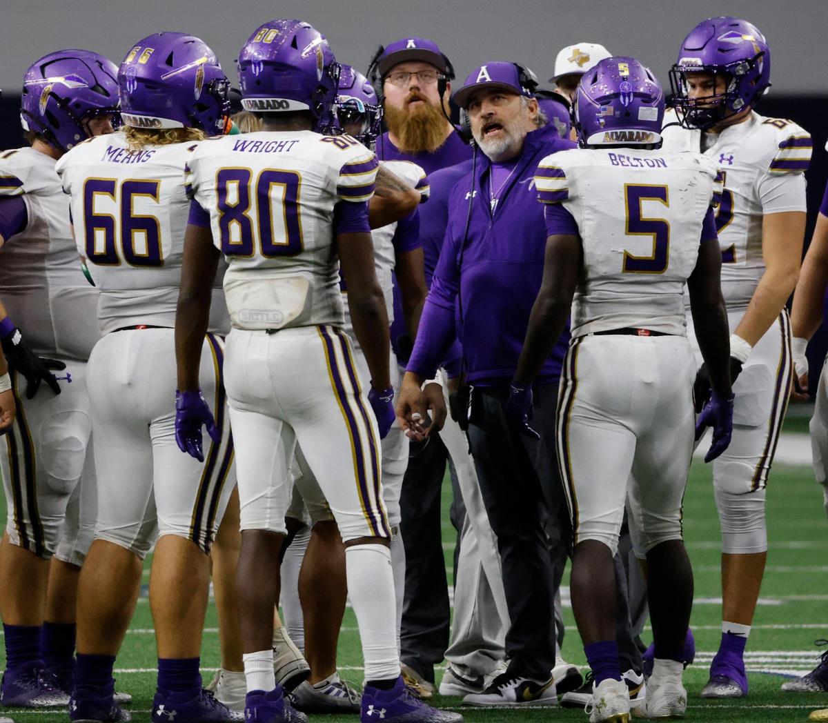 Alvarado head coach Casey Walraven talks to the team during a late first half time out during a UIL 4A D1 Area round football playoff game at The Ford Center in Frisco Texas, Thursday, Nov. 21, 2024.