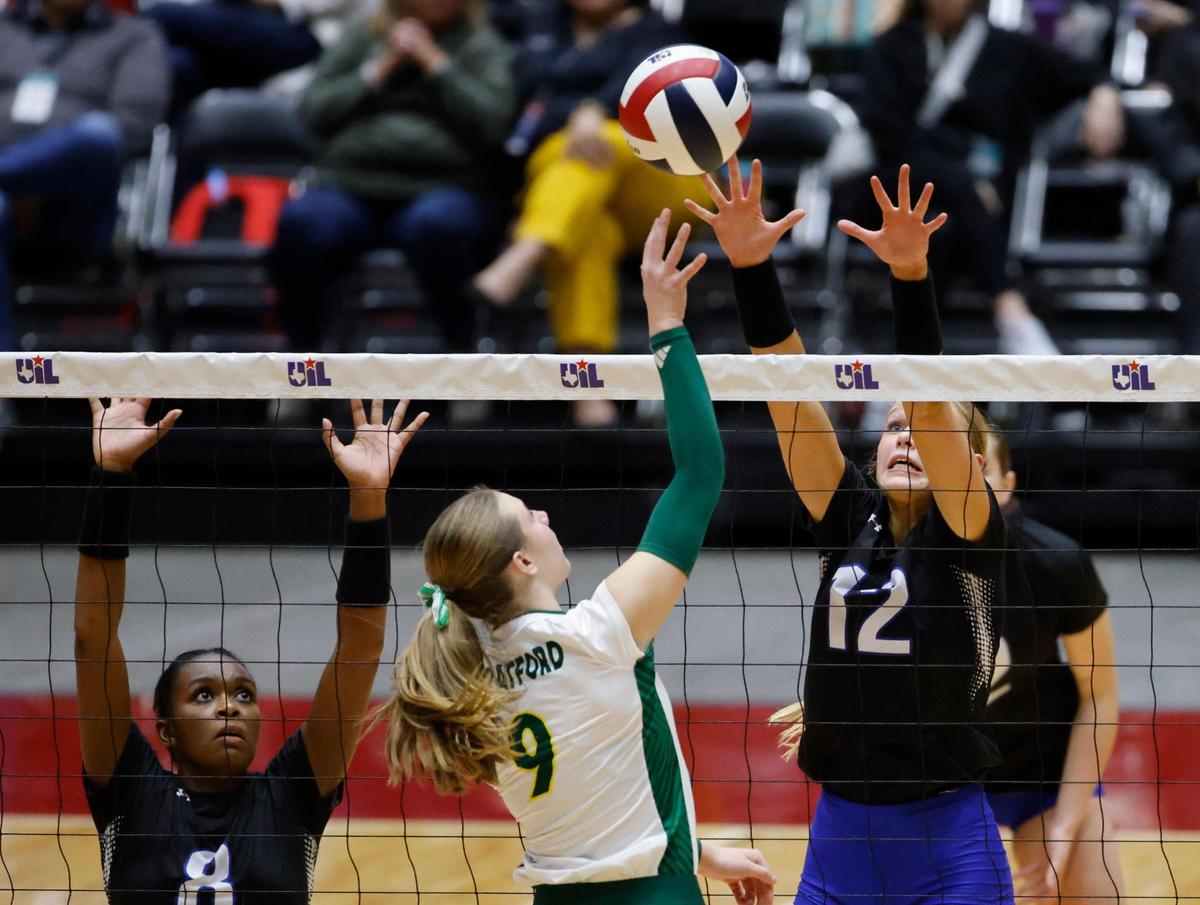 Houston Stratford Tess Stephenson (9) tips the ball into the defense of Byron Nelson Ashlyn Seay (12) during the UIL 6A D2 State Final volleyball match at Curtis Culwell Center in Garland Texas, Saturday, Nov. 23, 2024.