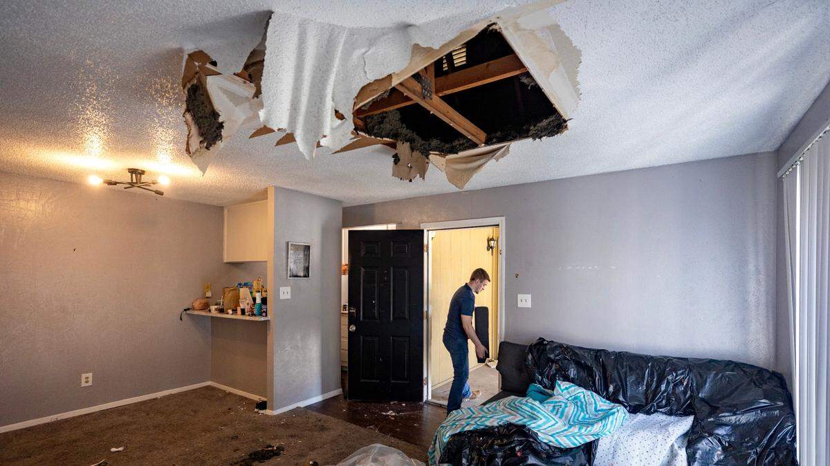Logan Bishop moves furniture out of his apartment after his ceiling collapsed the day before during severe thunderstorms in Weatherford on Friday. Insulation, debris and water came pouring out of the ceiling as hard winds whipped Bishop’s apartment building.