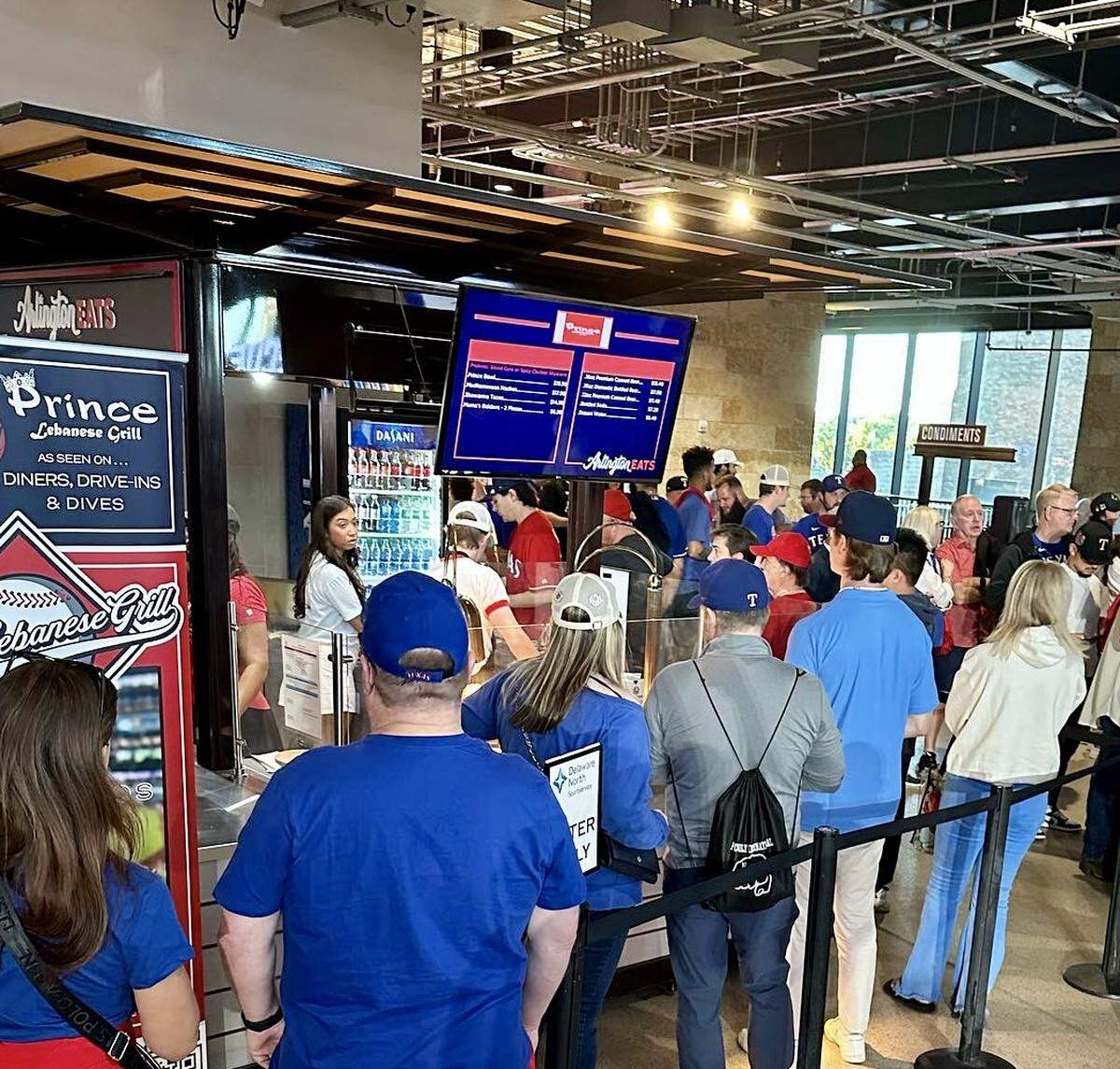 Long lines at a Prince Lebanese Grill booth at a Texas Rangers game in Globe Life Field.
