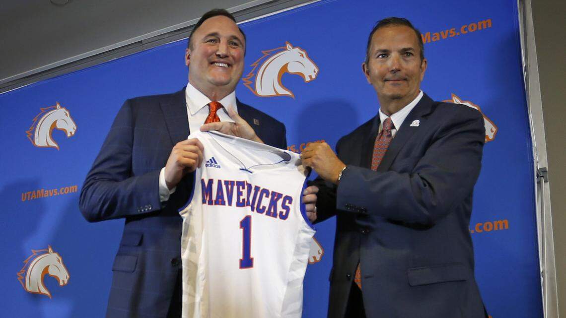 UTA introduced its new men's basketball coach, Chris Ogden (left), who received a jersey from UTA Director of Athletics Jim Baker (right) at a press conference in Arlington, Friday, April 6, 2018.