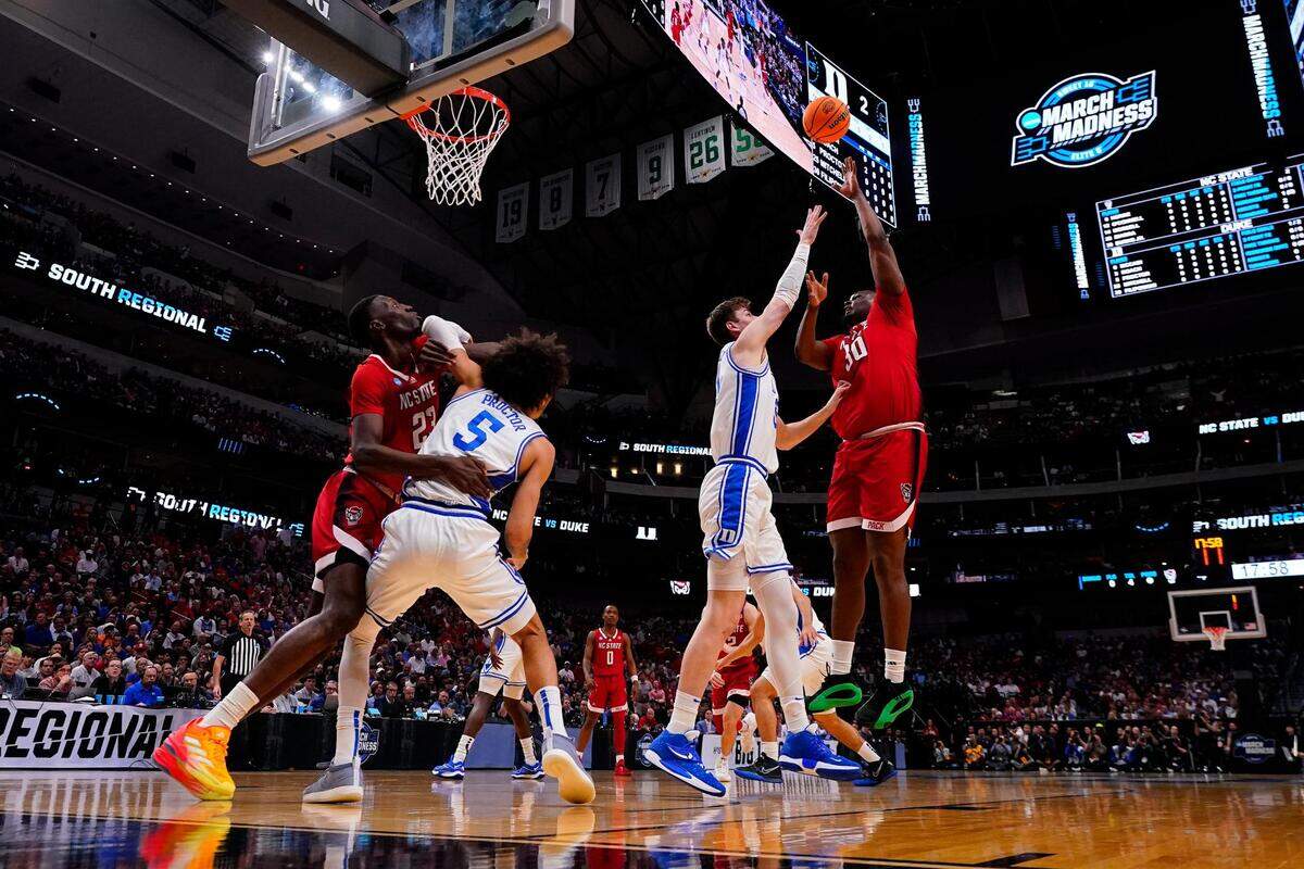 NC State forward DJ Burns Jr. (30) shoots a hook shot over Duke center Kyle Filipowski (30) in the first half of the Elite 8 South Regional Championship game of NCAA Division I Mens Basketball Tournament at American Airlines Center in Dallas on Sunday, March 31, 2024. NC State defeated Duke 76-64.