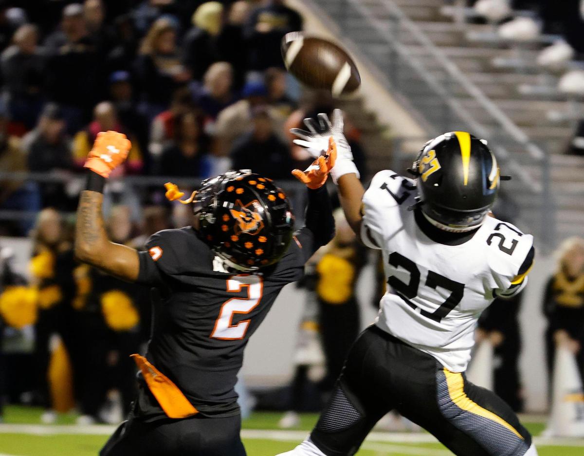 Forney defensive back Josiah Turner (27) intercepts a ball intended for Aledo receiver Jaden Allen (2) during the first half of a UIL Conference 5A Division I Semifinal football playoff game at Midlothian ISD Stadium in Midlothian, Texas, Friday, Dec. 08, 2023.
