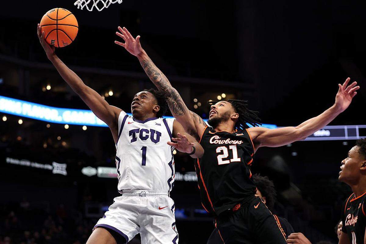 KANSAS CITY, MISSOURI - MARCH 11: Jayden Pierre #1 of the Texas Christian University Horned Frogs drives to the basket as Isaiah Coleman #21 of the Oklahoma State Cowboys defends during the second round game of the Men's 2026 Big 12 Tournament at T-Mobile Center on March 11, 2026 in Kansas City, Missouri. (Photo by Jamie Squire/Getty Images)