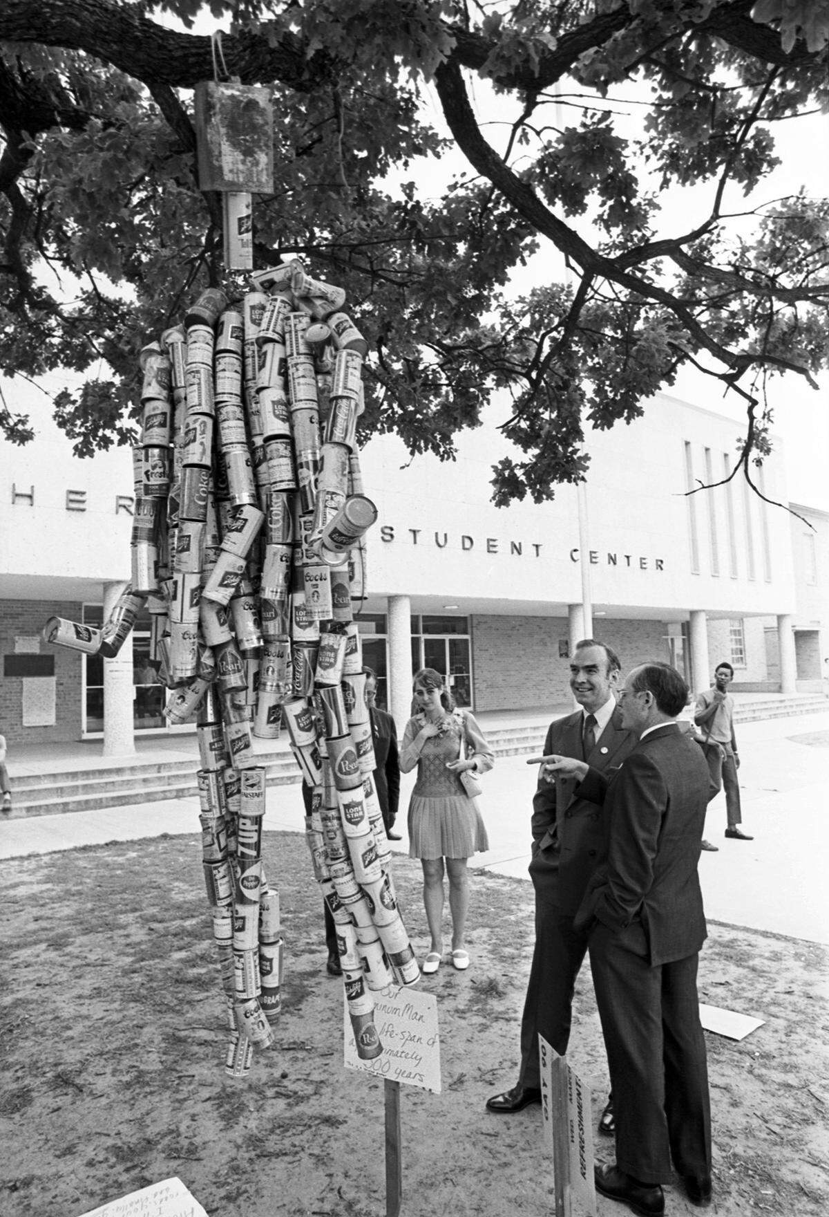 April 22, 1970: U.S. Rep. Jim Wright, second from left, and University of Texas at Arlington President Frank Harrison talk next to an “Aluminum Man” sculpture, hanging from a tree and made out of aluminum cans, with a sign that reads “Our ‘Aluminum Man’ has a life-span of approximately 500 years.” Wright visited the UTA campus for Earth Day activities, speaking to students and helping bury an internal combustion engine symbolic of automobile pollution.