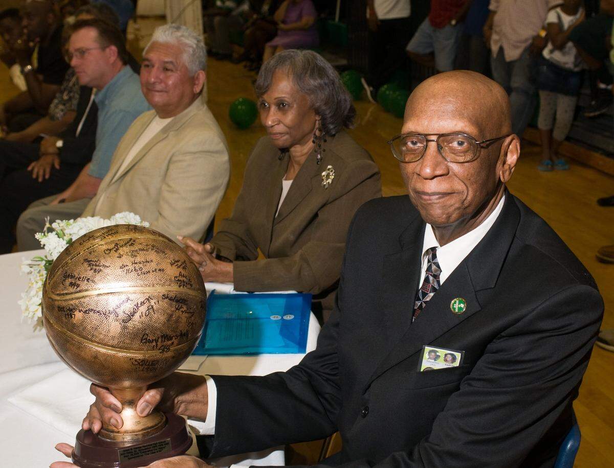 In this photo from the Star-Telegram archives, John Gales holds a basketball with alumni autographs of his Trimble Tech students and players when he was a coach at the school. Gales, a graduate of I. M. Terrell High School and James E. Guinn Middle School, was honored at the dedication of the John Gales Gym at Tremble Tech High School in 2009.