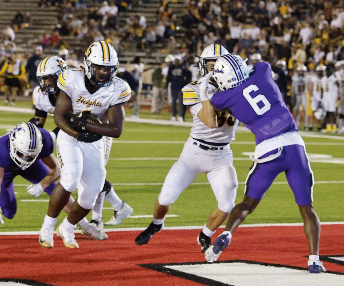 Arlington Heights running back Carson James (1) scores on a short run during the first half of a UIL football game between Arlington Heights and Paschal at Farrington Field in Fort Worth, Texas, Friday Nov. 07, 2025.