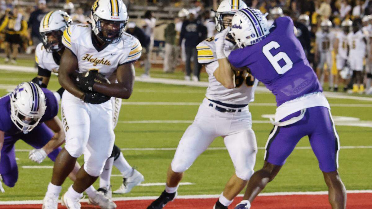 Arlington Heights running back Carson James (1) scores on a short run during the first half of a UIL football game between Arlington Heights and Paschal at Farrington Field in Fort Worth, Texas, Friday Nov. 07, 2025.