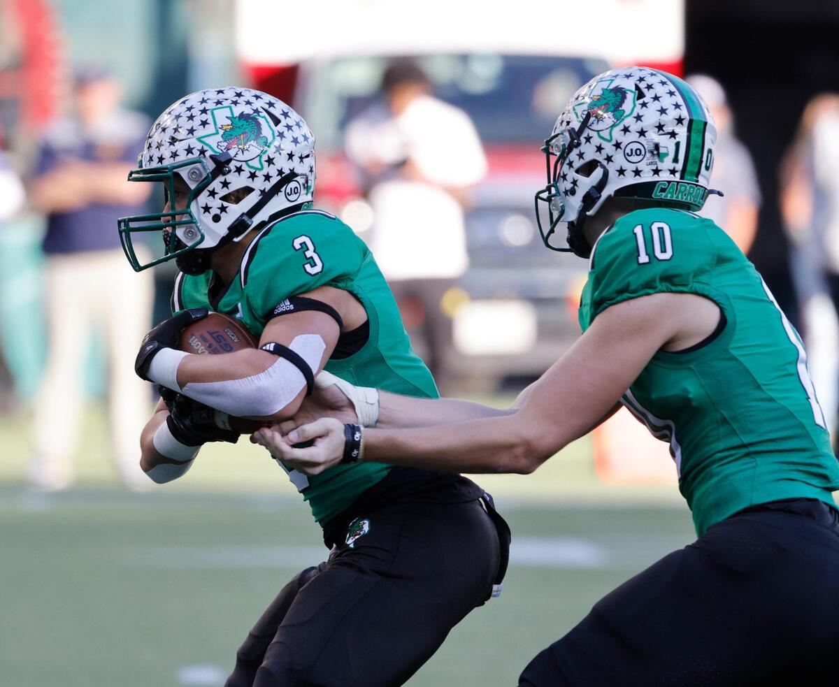 Southlake Carroll running back Davis Penn (3) takes the ball from quarterback Graham Knowles (10) in the first half of a UIL Conference 6A Division 2 regional-round football playoff game at Choctaw Stadium in Arlington, Texas, Friday, Nov. 24, 2023.