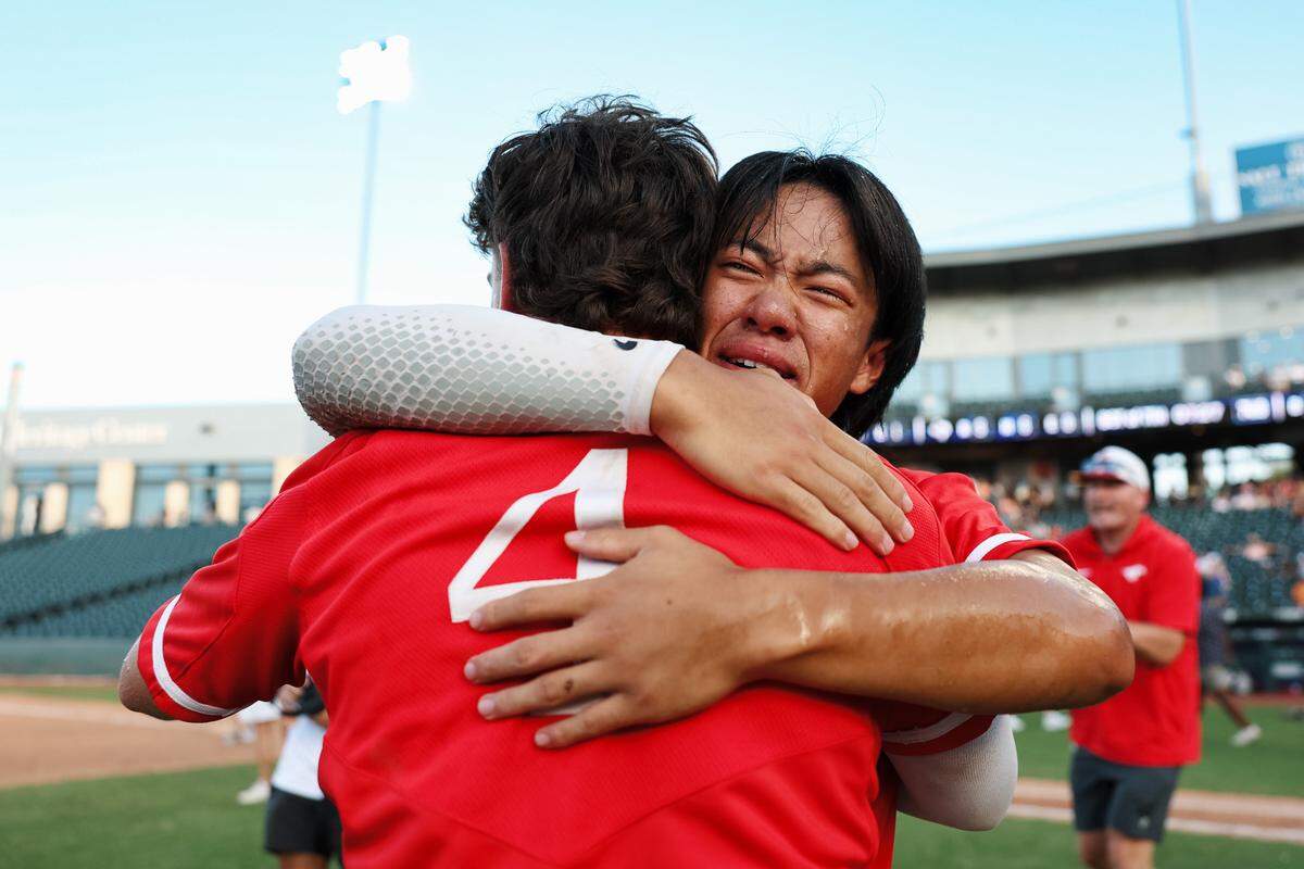 Grapevine outfielder Derek Duong is in tears as he hugs his teammate Thomas Powers (4) after the Mustangs defeated Kingwood Park 9-5 in the Class 5A Division II state championship game on Friday, June 6, 2025 at Dell Diamond in Round Rock, Texas.