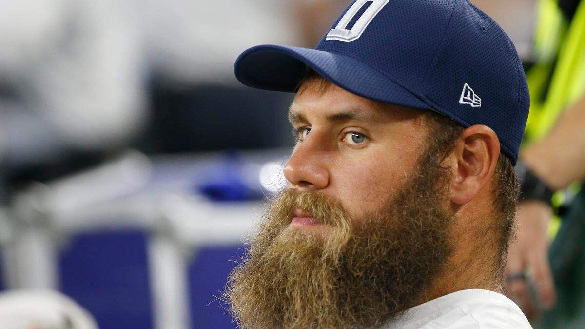 Cowboys center Travis Frederick looks on from the sidelines during the first half of a preseason NFL football game against the Arizona Cardinals in Arlington, Texas, Sunday, Aug. 26, 2018. (AP Photo/Ron Jenkins)