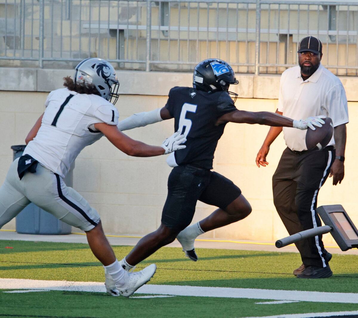 North Crowley wide receiver Quentin Gibson (6) extends the ball for six in front of Guyer linebacker Kaadyn Cobbs (1) during a UIL football game at Crowley ISD Sports Complex in Fort Worth Friday, Sept. 13, 2024.