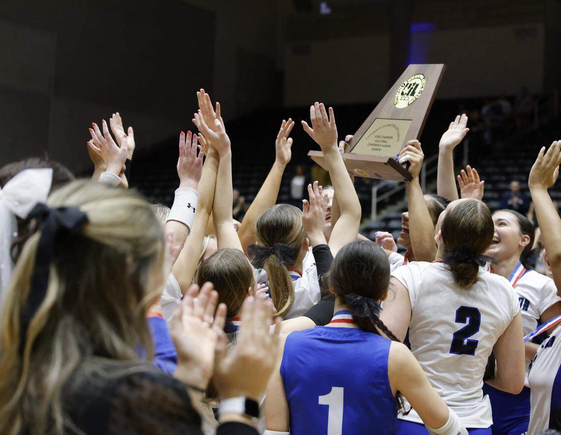 Trophy Club Byron Nelson Lady Cats celebrate with the championship trophy after defeating Pearland Dawson for the UIL Class 6A Division I state volleyball championship game Saturday Nov. 22, 2025 at Curtis Culwell Center in Garland, Texas.