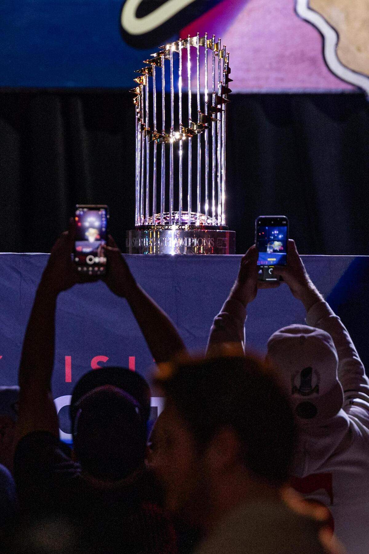 Fans take photos of the World Series Commissioners Trophy at the World Series celebration event at Billy Bob’s Texas in Fort Worth on Thursday, Nov. 9, 2023.