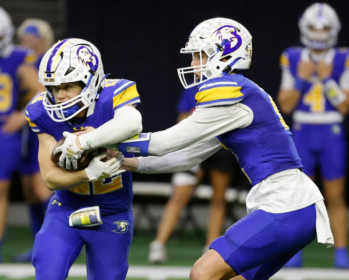 Brock running back Brett Tutter (22) takes the ball from quarterback Brody Woods (2) during the second half of a UIL Conference 3A Division 1 semifinal playoff football game at The Ford Center in Frisco, Texas, Thursday, Dec. 07, 2023.