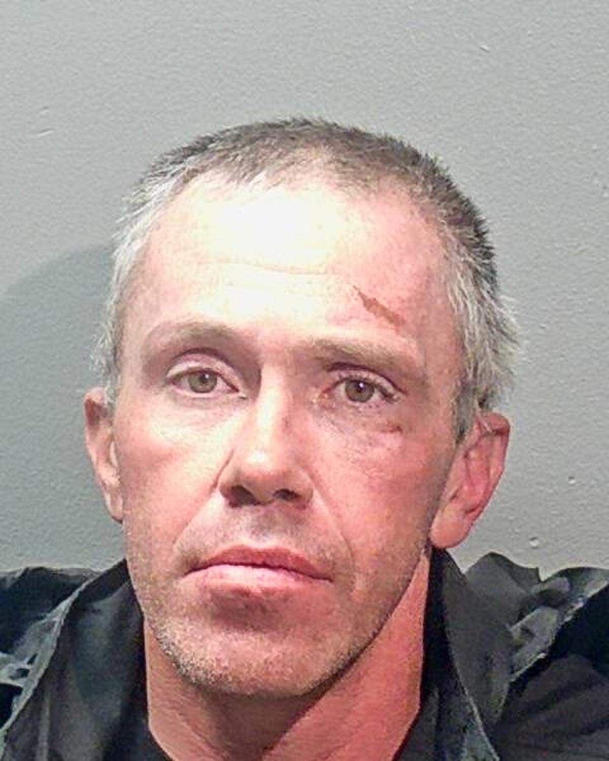 Photo of a man wearing a black shirt or jacket.