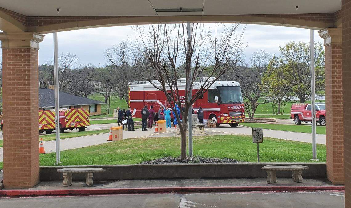 A task force consisting of medical personnel from the Arlington Fire Department, the Texas Department of State Health Services and Tarrant County Public Health prepare to test residents and staff at the Texas Masonic Lodge Retirement Center in Arlington.