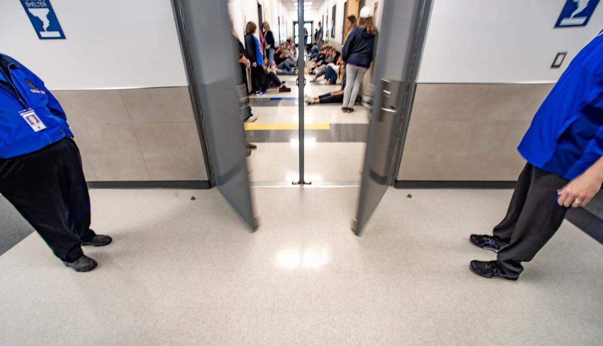 Lipan school district administrators stand outside the safe wing of the high school as the doors close during an evacuation drill. The $9.4 million addition was paid for by a school bond that was overwhelmingly approved by voters in 2021. Photo taken Friday, March 24, 2023.