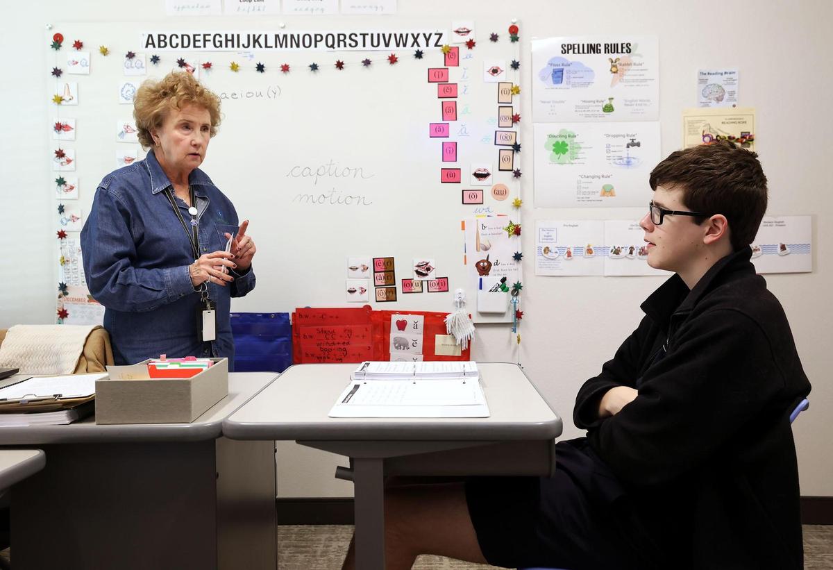 Ann Christian, a certified academic language therapist, works with Andrew James, 16, during a one-on-one session at Key School and Training Center on Dec. 5, 2024, in Fort Worth. James transferred to Key School in 2020 and was diagnosed with dyslexia soon after.