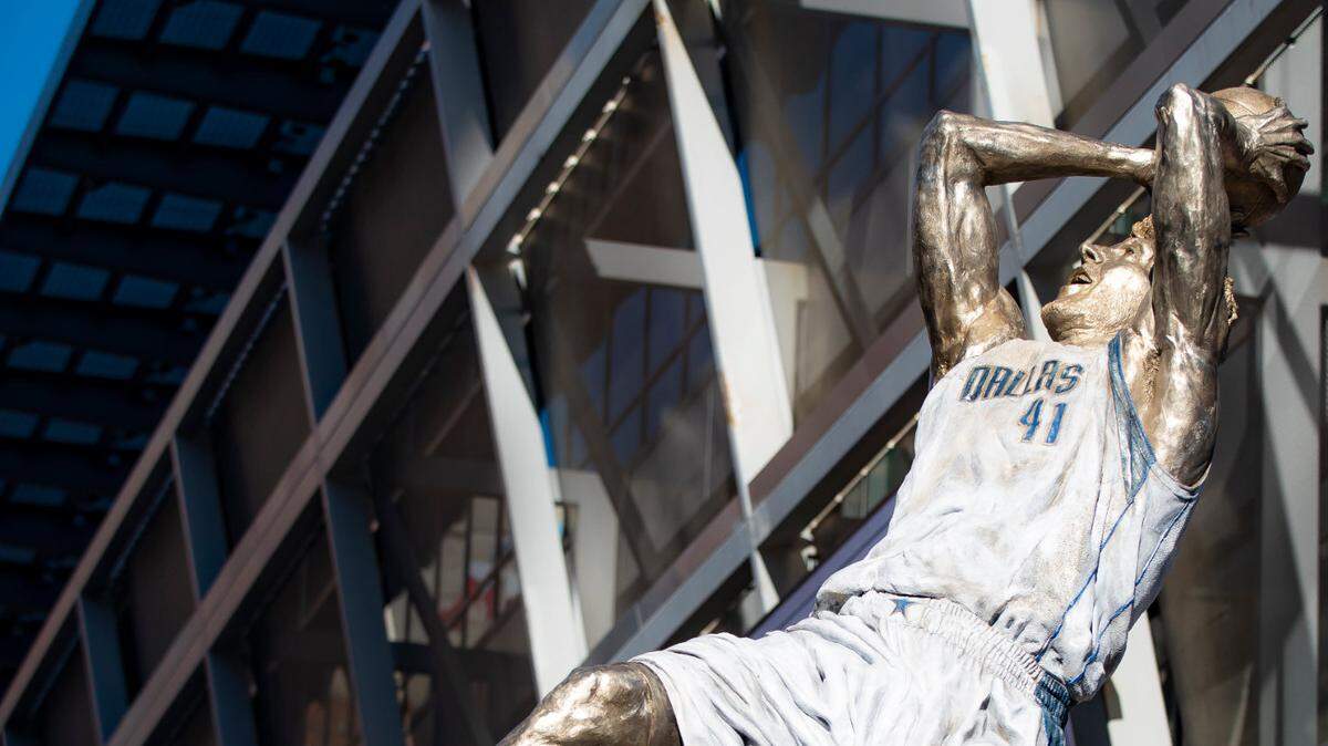 Dirk Nowitzki’s statue is unveiled during the “All Four One” statue ceremony in front of the American Airlines Center in Dallas, on Sunday.