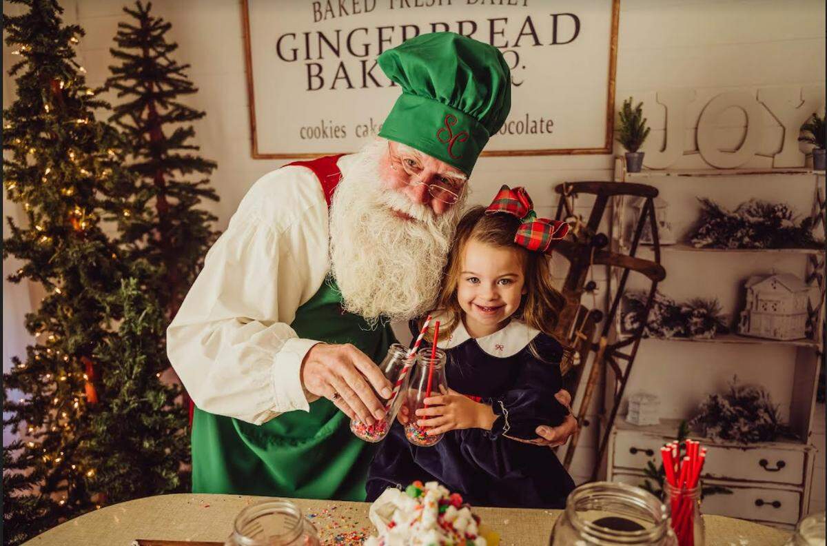 Mike “Santa Pappy Claus” Stevens of Bedford, Texas says it’s never too early for the Christmas magic. Savannah Derrick, 3, of Fort Worth, Texas, agrees.