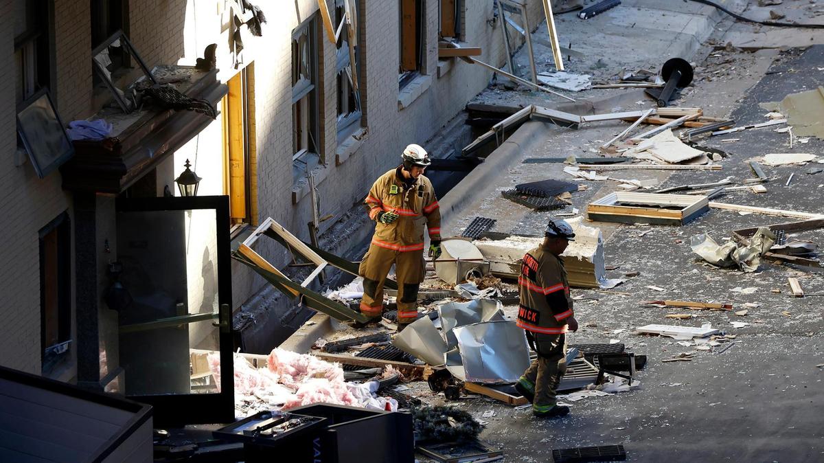 Members of the Fort Worth Fire Department inspect the rear of the Sandman Signature Hotel facing Throckmorton Street on Tuesday, January 9, 2024, in downtown Fort Worth. Multiple people were injured in the explosion Monday afternoon, with 21 hospitalized or treated on scene, according to the fire department and MedStar.