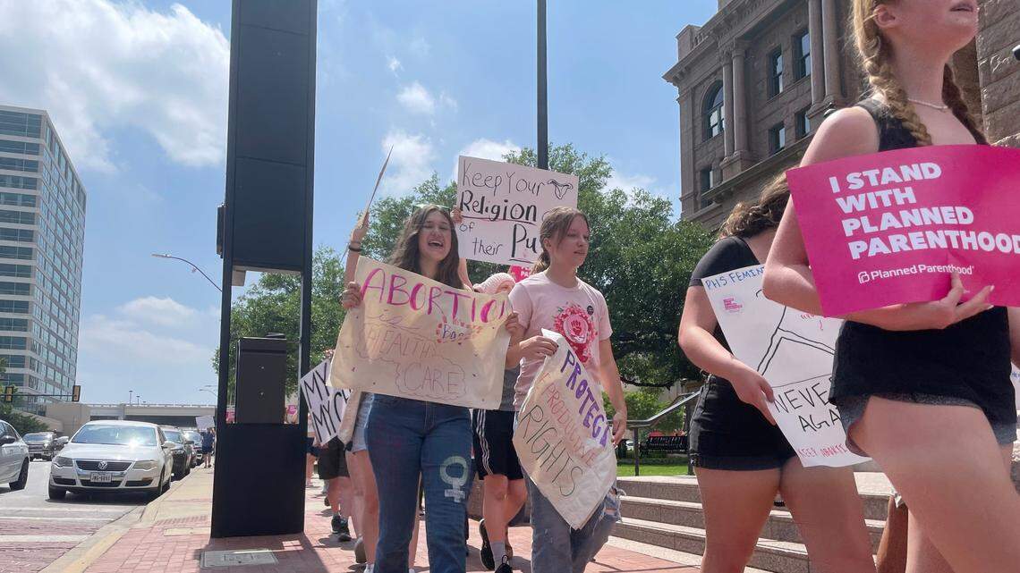 Students from Paschal High School’s feminist club march through Fort Worth Saturday in support of abortion rights.