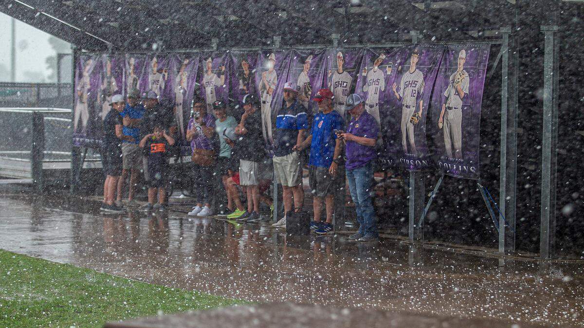 Hail pummels Tidwell Field at Granbury High School, Monday, May 3, 2021, as parents and student take shelter under the stands.