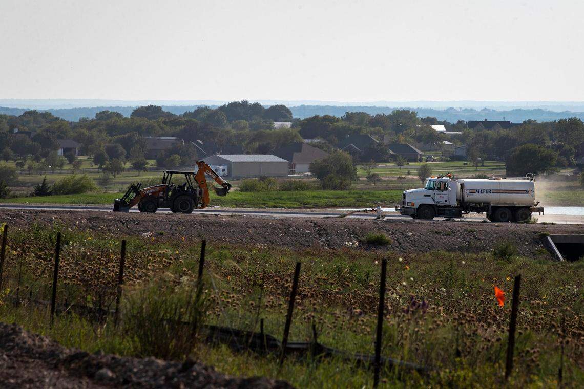 A utility truck drives across a construction site for future housing development in Rhome, Texas, on Thursday, Sept. 8, 2022.