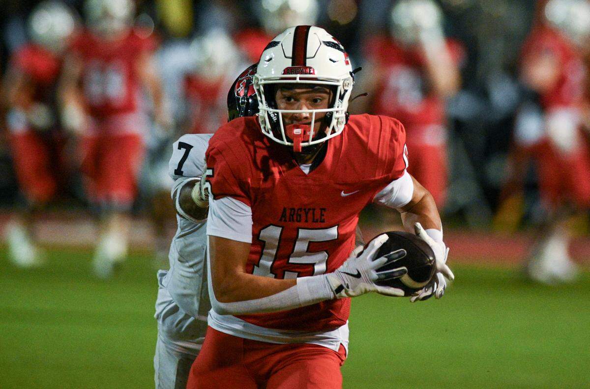 Argyle wide receiver Ake O’Neal (15) runs down the field after a catch during a UIL football game against Colleyville Heritage at Eagle Stadium in Argyle, Texas on Friday, Sept. 27, 2024.