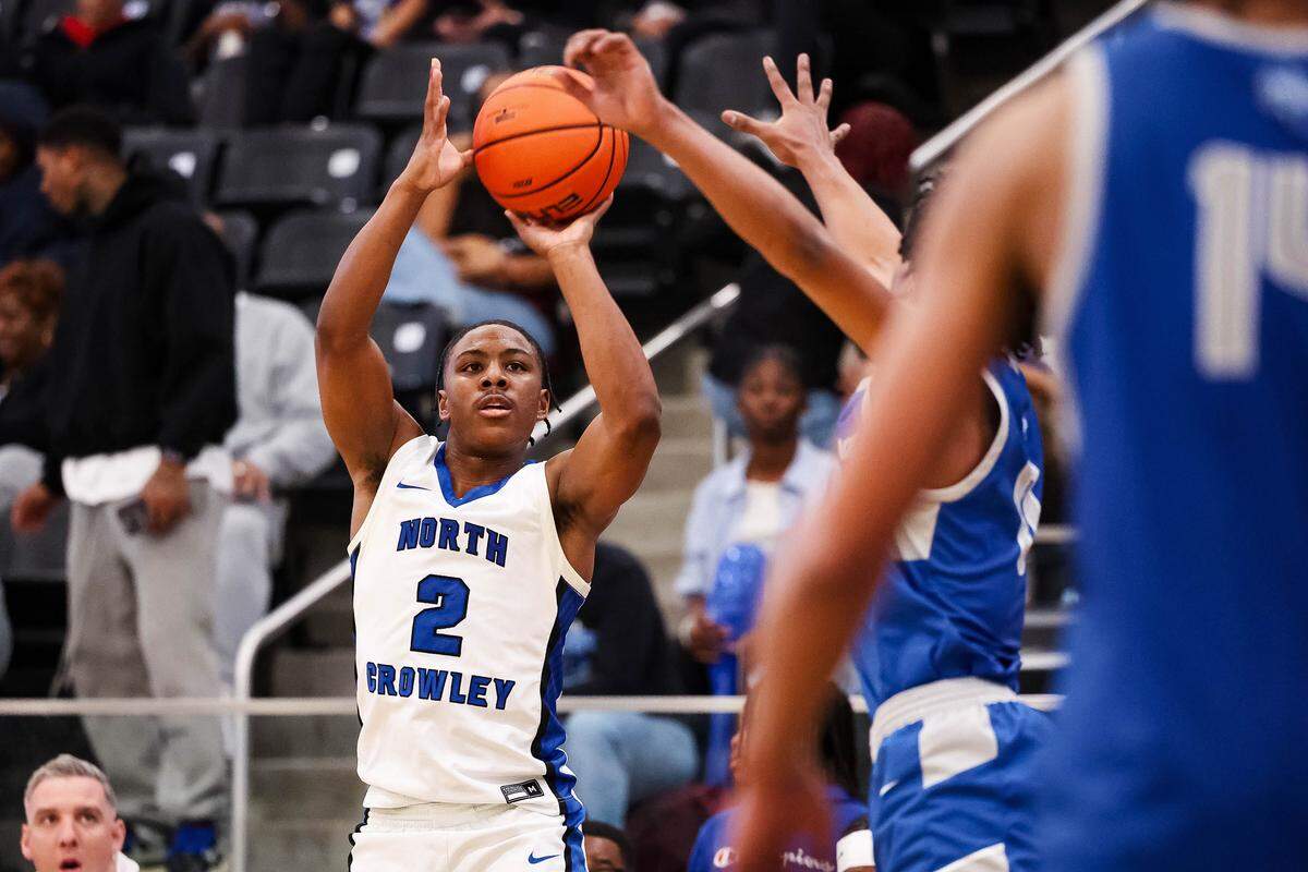 North Crowley guard Kameron Price (2) attempts a 3-pointer as a Weatherford defender closes in during a District 3-6A matchup Friday at North Crowley.