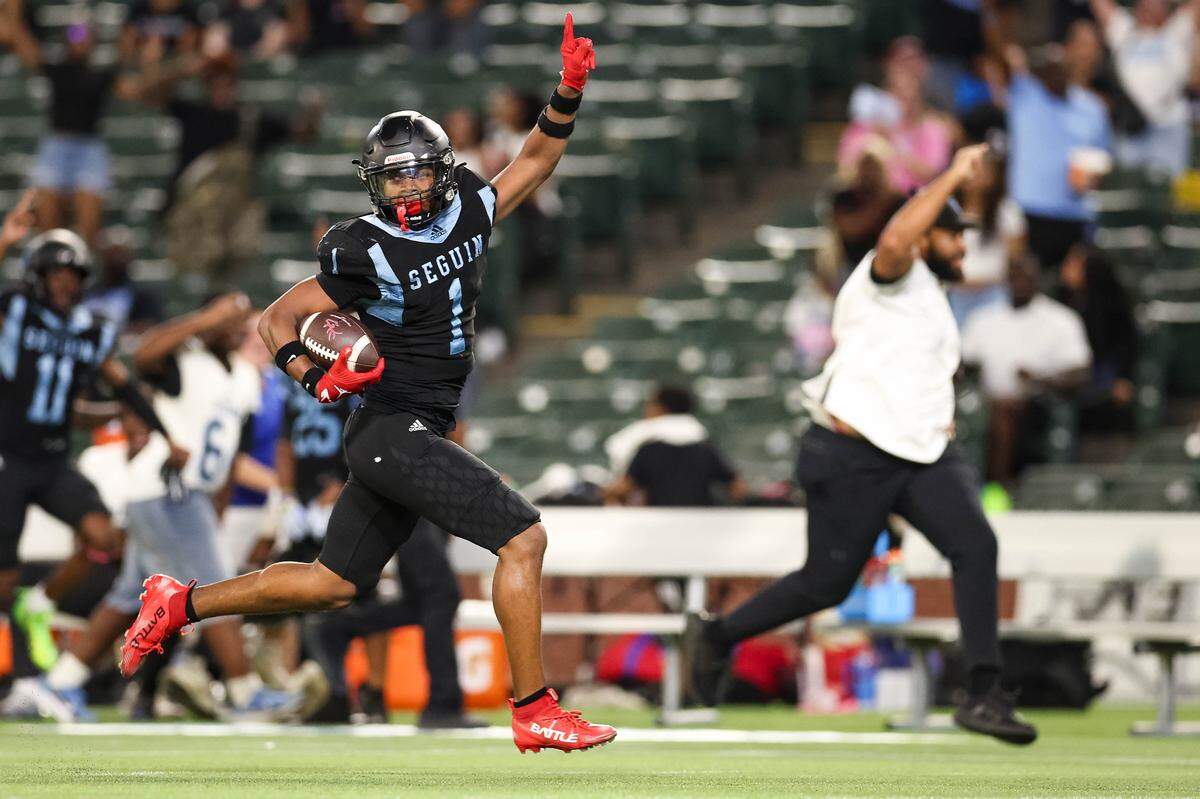 Arlington Seguin linebacker Da'Shaun Marable puts a finger in the air while running after intercepting a pass that resulted in a defensive touchdown in a district game between Arlington Seguin and Burleson at Choctaw Stadium in Arlington, Texas on Sept. 11, 2025.