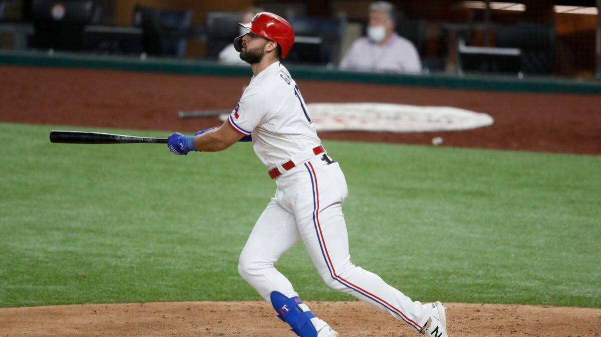 Texas Rangers’ Joey Gallo follows through on a two-run home run that came off a pitch from Los Angeles Angels starter Patrick Sandoval in the sixth inning of a baseball game in Arlington, Texas, Saturday, Aug. 8, 2020. The Rangers’ Todd Frazier scored on the hit. (AP Photo/Tony Gutierrez)