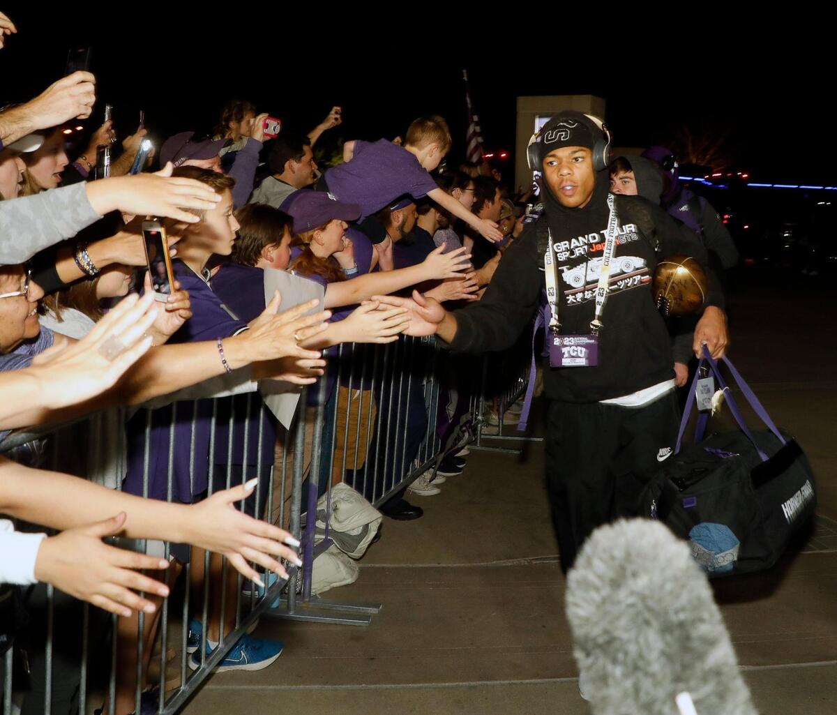 TCU safety DeShawn McCuin greets fans after the team returns from the CFP national championship football game to the TCU Campus in Fort Worth, Texas, Tuesday, Jan. 10, 2023.