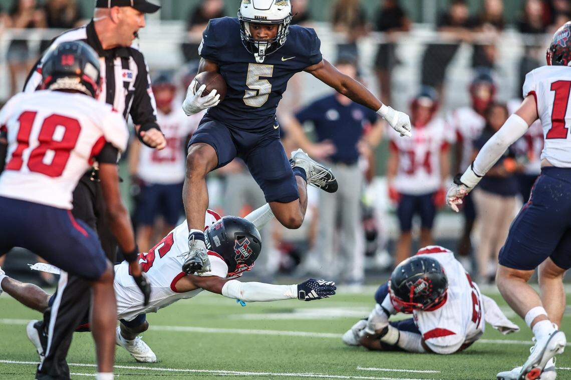 Keller running back Quintin Shropshire jumps over a pair of  Northwest High School’s defenders in Friday’s District 4-6A game at Keller ISD Stadium. Tom Marvin / Special to the Star-Telegram