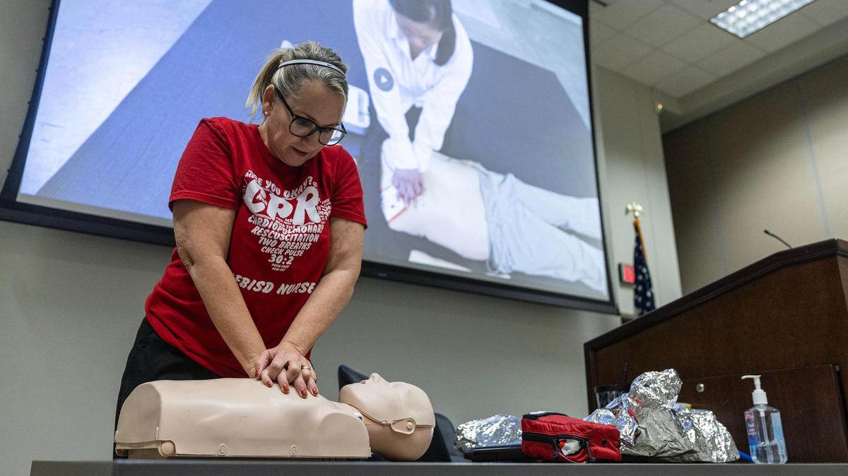 Joy Keohane, the HEB school district health services coordinator, shows class attendees how to do chest compressions during a CPR class at the Pat May Center in Bedford in October.