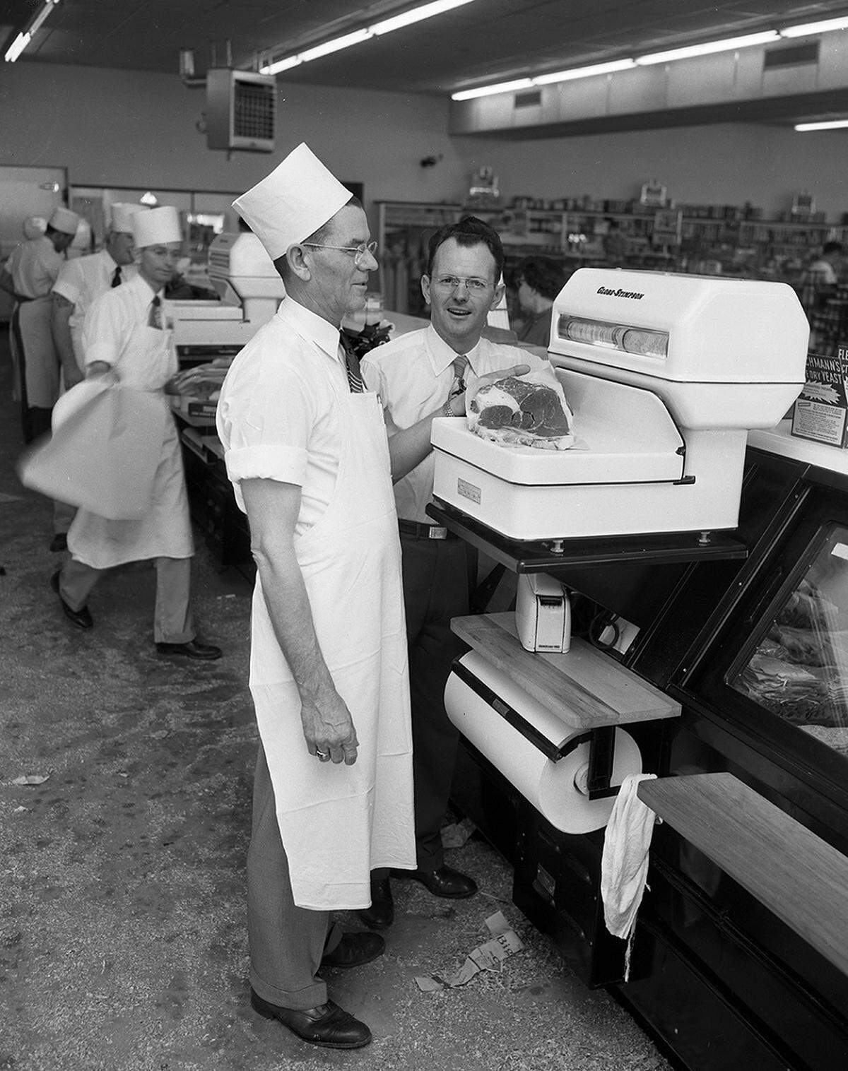 Jan. 14, 1953: Adrian Allen, left, meat market manager, and Vernon McDonald, grocery department manager at Worth Food Market at Hemphill and Berry were ready Thursday for the formal opening of the new store Friday and Saturday. Allen is weighing a piece of meat while McDonald looks on.