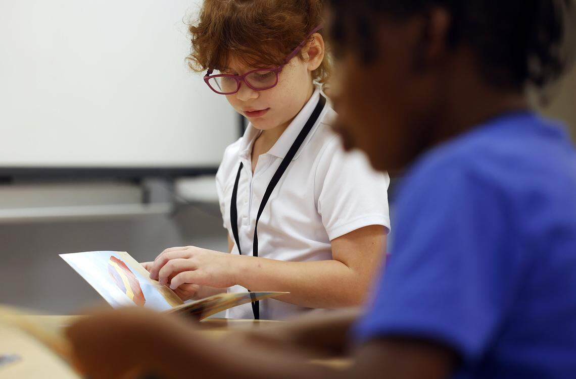Second graders Gabriela Ringnald, left, and  Malachi Murkledove, look through a book during a tutoring session at Westpark Elementary School on Thursday, Sept. 19, 2025. 