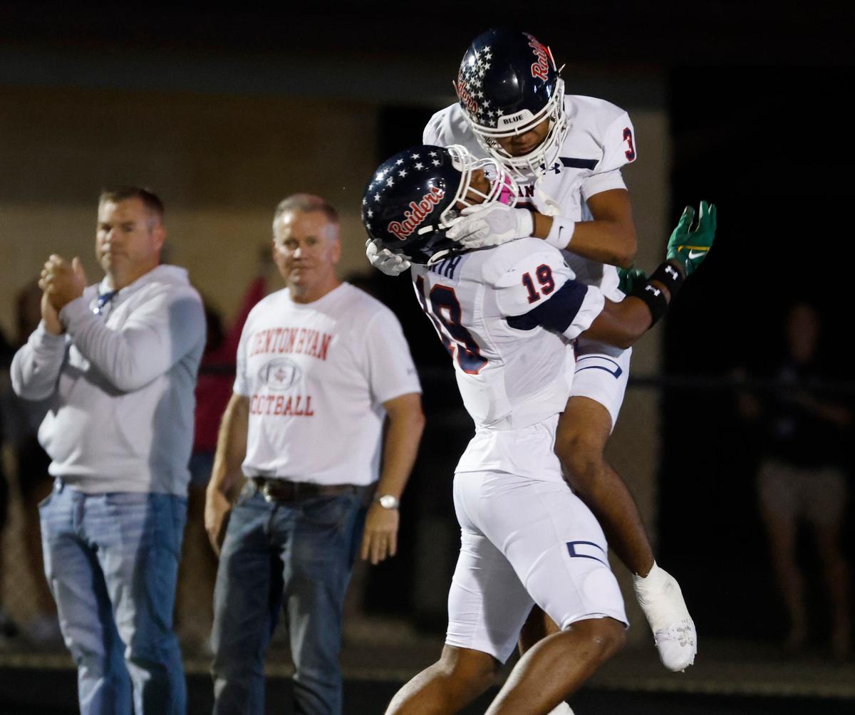 Denton Ryan wide receiver Raymond Smith (19) lifts wide receiver Lorenzo Hill (3) after Hill scored six during a UIL football game at Buchanan Stadium in Aledo wide receiver Raymond Smith (19) lifts Denton Ryan wide receiver Lorenzo Hill (3) after Hill scored Texas, Friday, Oct. 04, 2024.