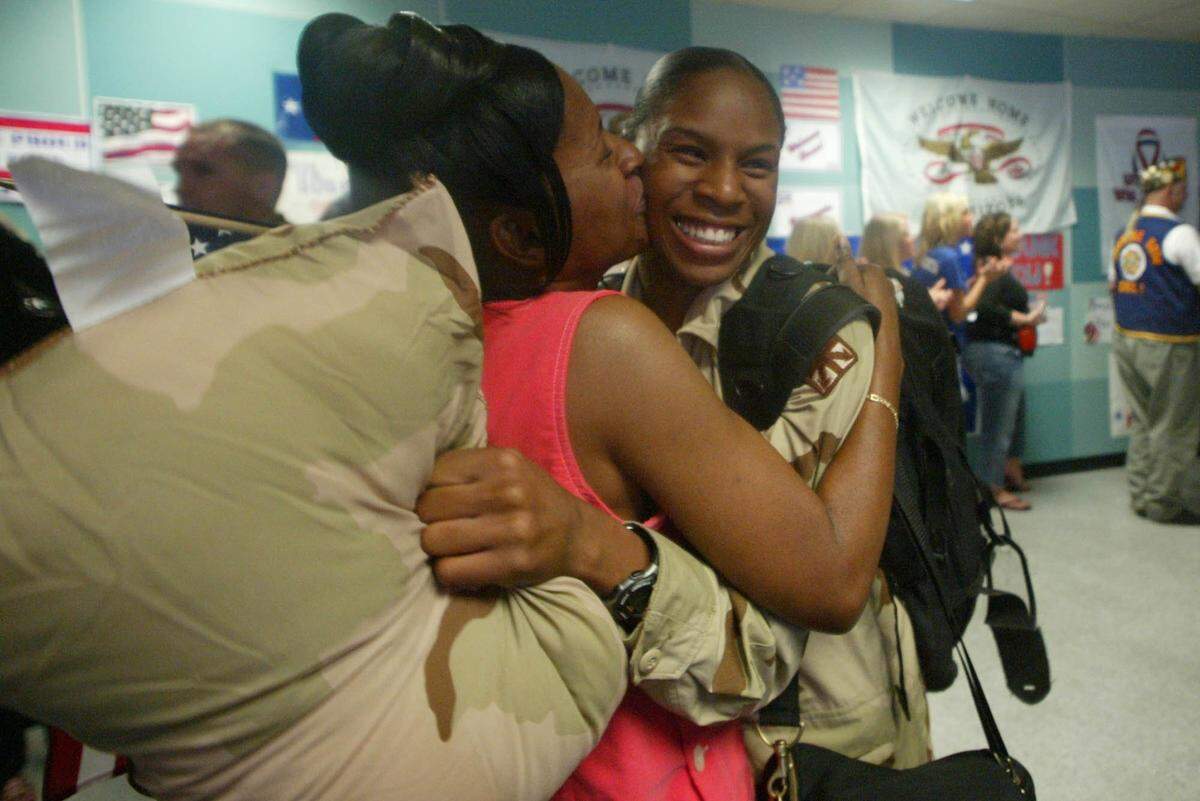 Aug. 26, 2004: Returning soldier Sandra Osbey, left, hugs her mother, Tiffany Osbey, at DFW Airport. Although Sandra Osbey had someone waiting for her, many soldiers did not, so area organizations volunteer to greet them.