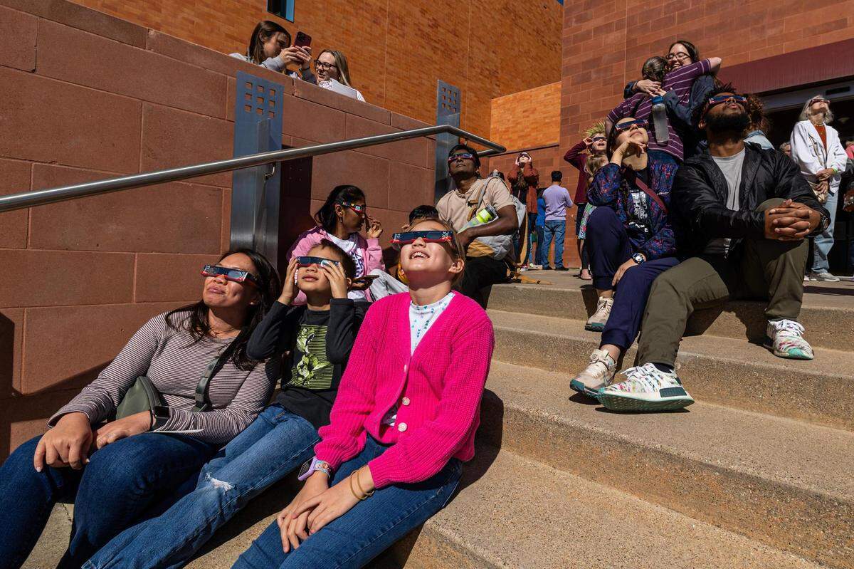 Spectators put on the solar goggles to view the eclipse during the Annular Solar Eclipse event at the Fort Worth Museum of Science & History on Saturday, Oct. 14, 2023.