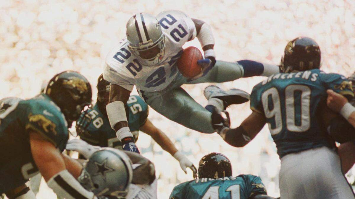 Former Cowboys running back Emmitt Smith flies over the goal line for a one-yard  touchdown against the Jacksonville Jaguars defense during a game in October 1997.